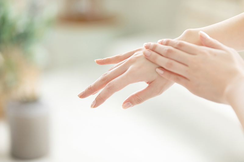 左手で右の手の甲をなでる様子